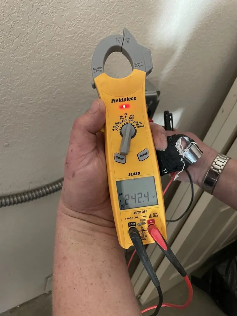 Voltage testing with clamp meter during Outlet Installation in St. George